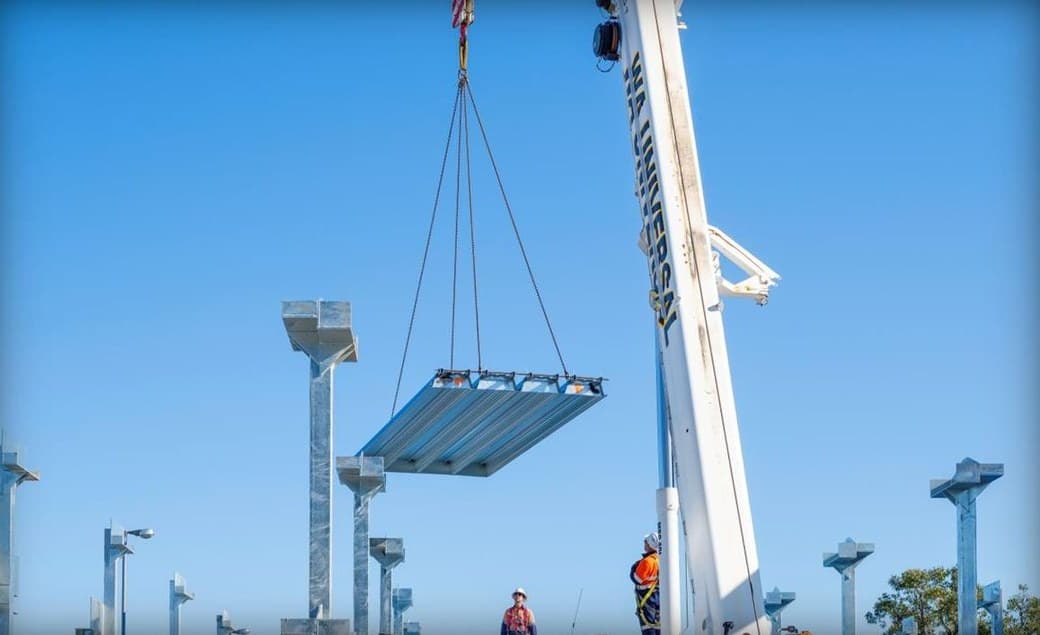 Crane lifting a prefabricated PARKD deck module into place